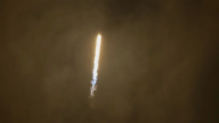 Rocket ascending through thick Venusian-style atmosphere, trailing fire and vapor.