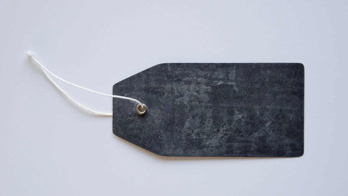 A blank dark label tag attached with a white string on a light background