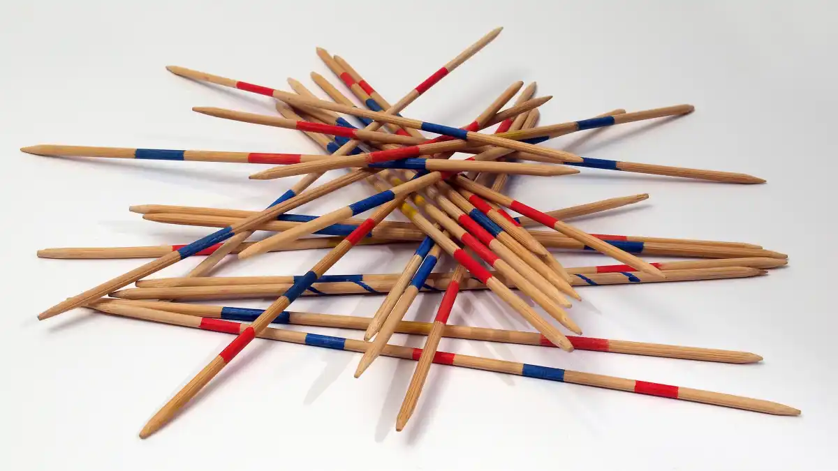Pile of Mikado pick-up sticks tangled together, symbolizing the fragile and interconnected structure of the global order