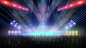A massive crowd stands beneath blinding concert lights while a gigantic female face looms above the stage like a digital apparition, symbolizing celebrity worship and mass spectacle.