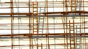 Wooden ladders and scaffolding form a dense grid across the façade of a building, creating a visual maze of interconnected ladders and platforms.